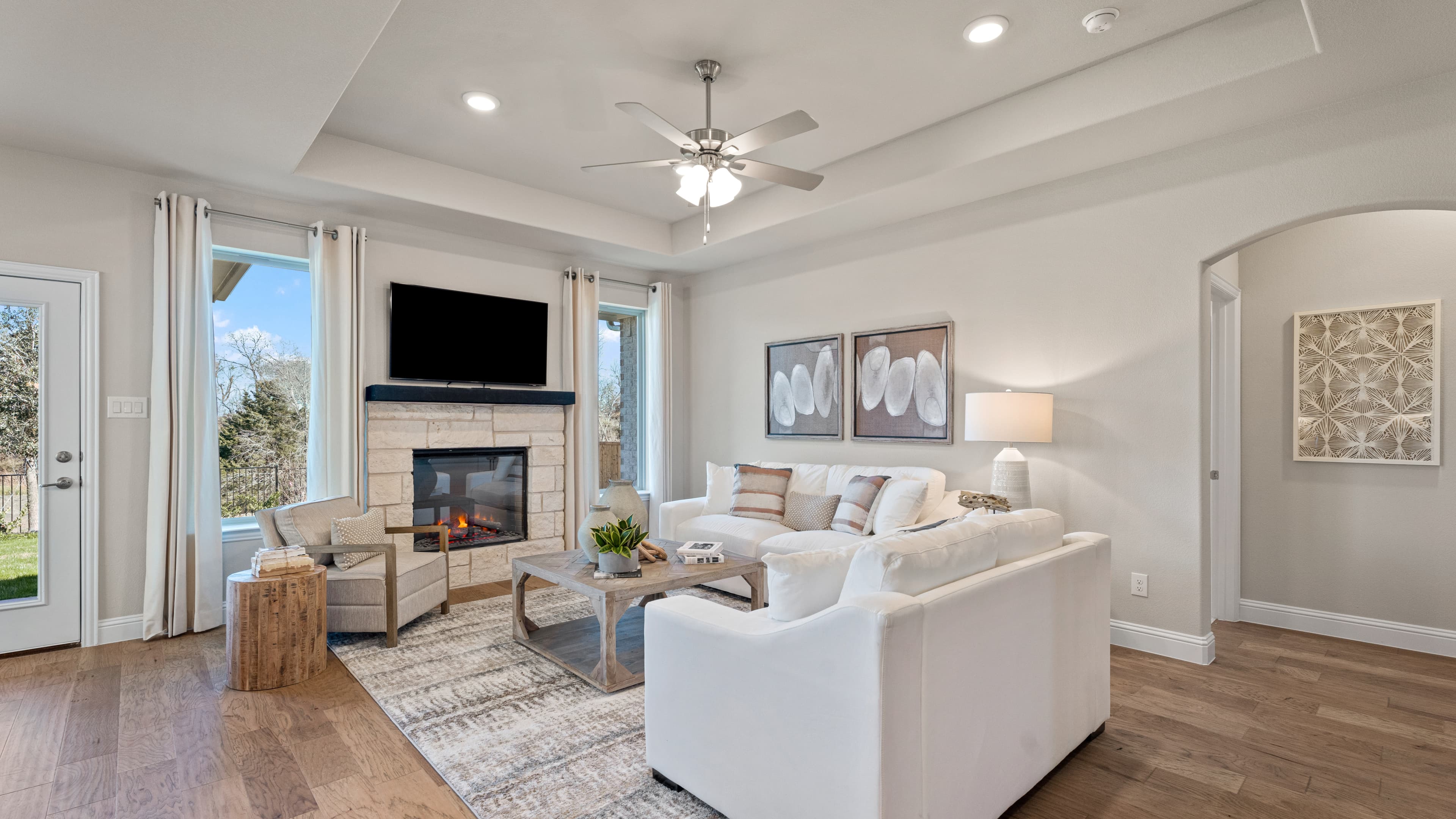 open great room with white stone fireplace