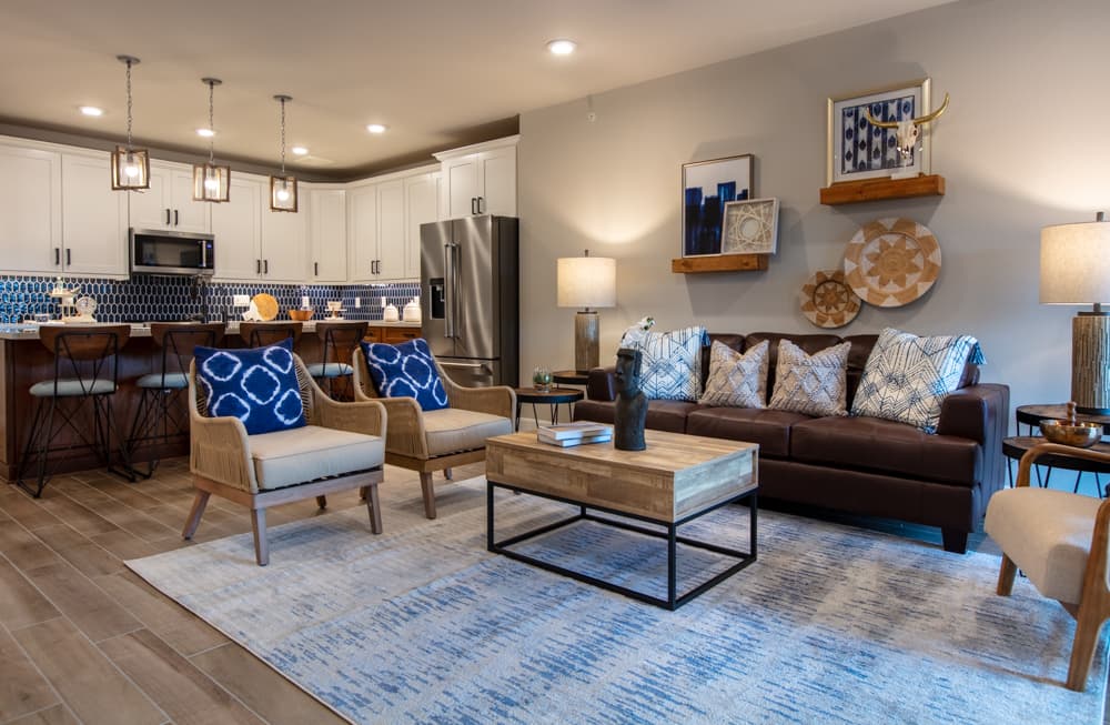 great room with wood-like tile and ceiling fan