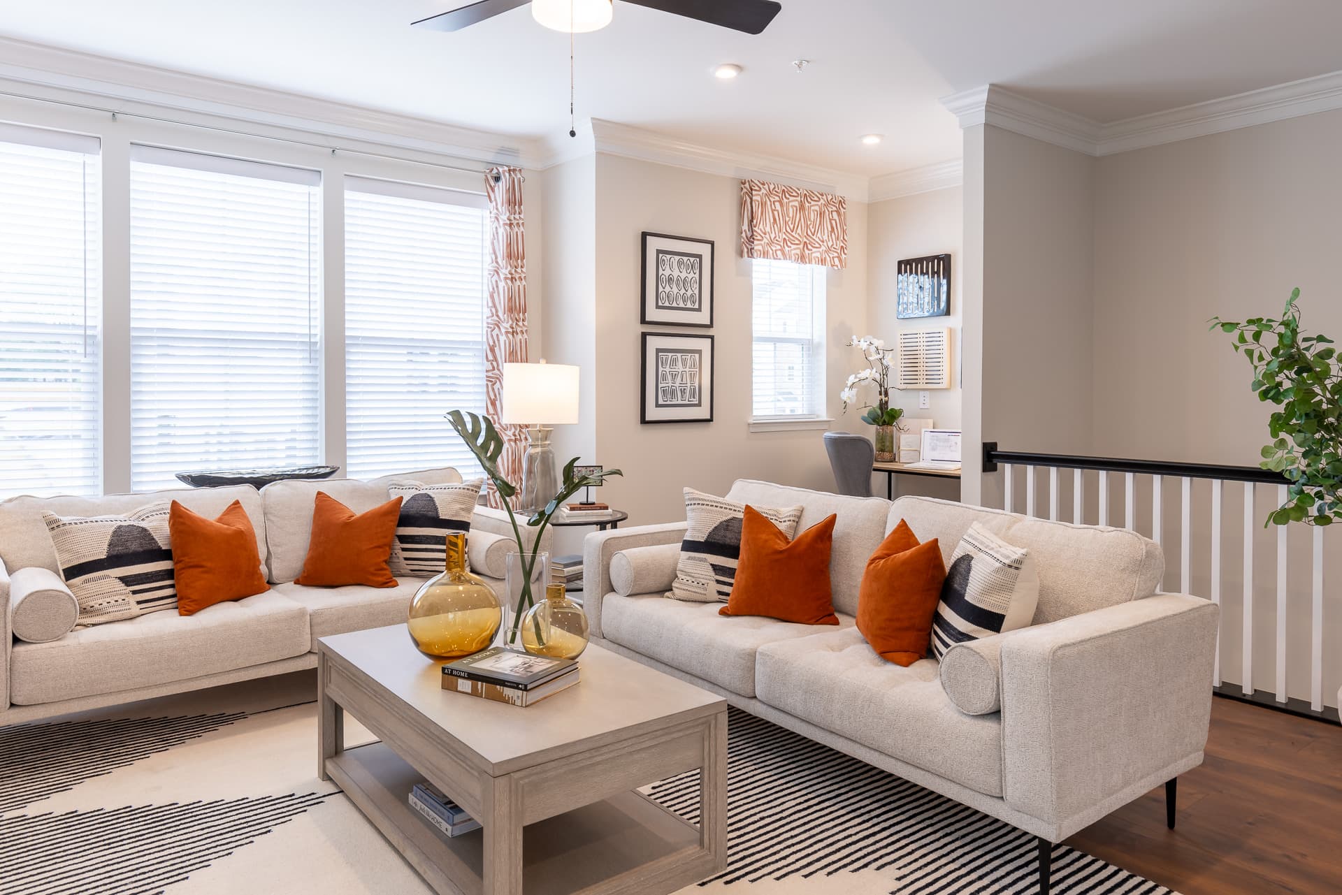 great room with 2 white couches and a rug