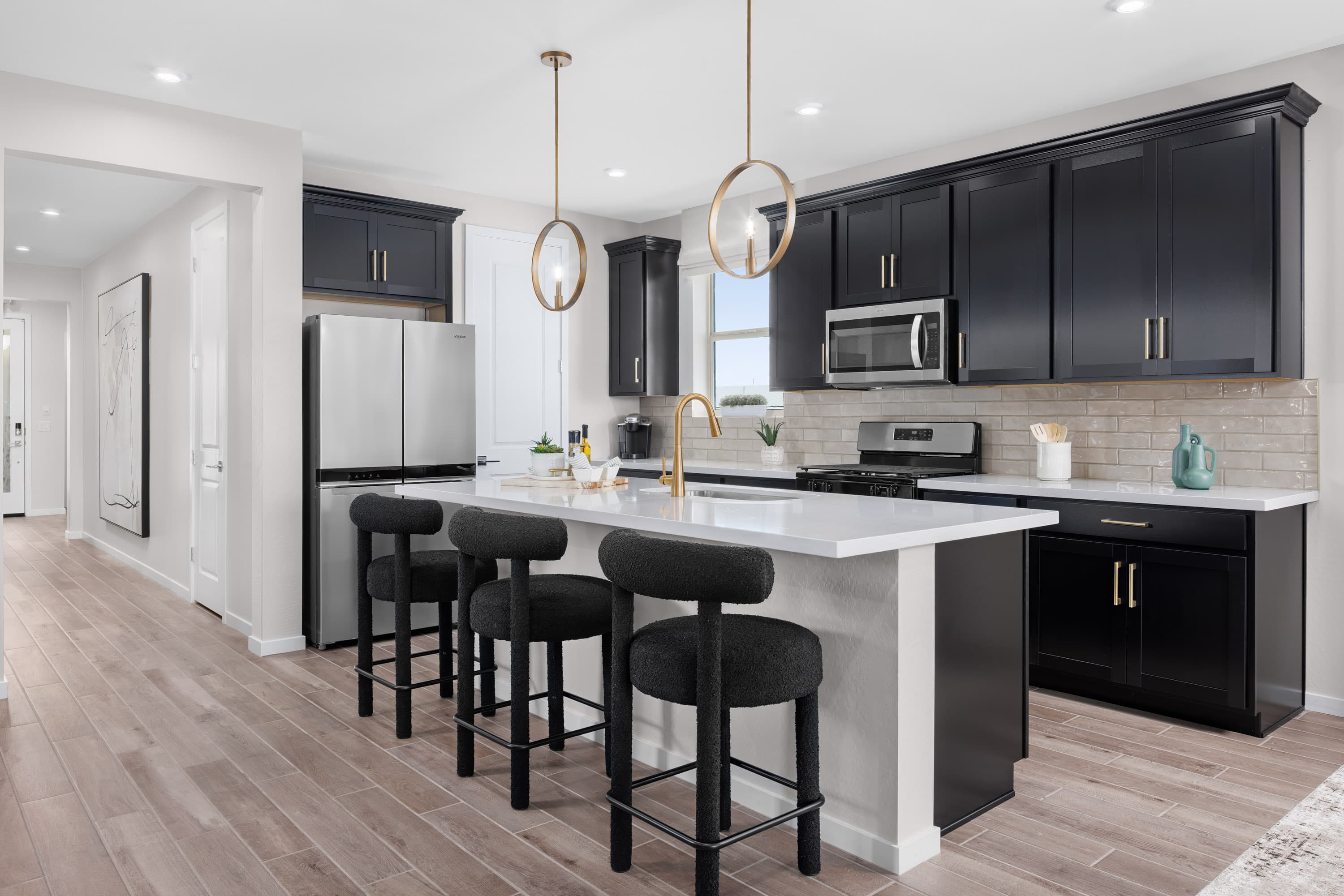 kitchen with black cabinets and bronze accents