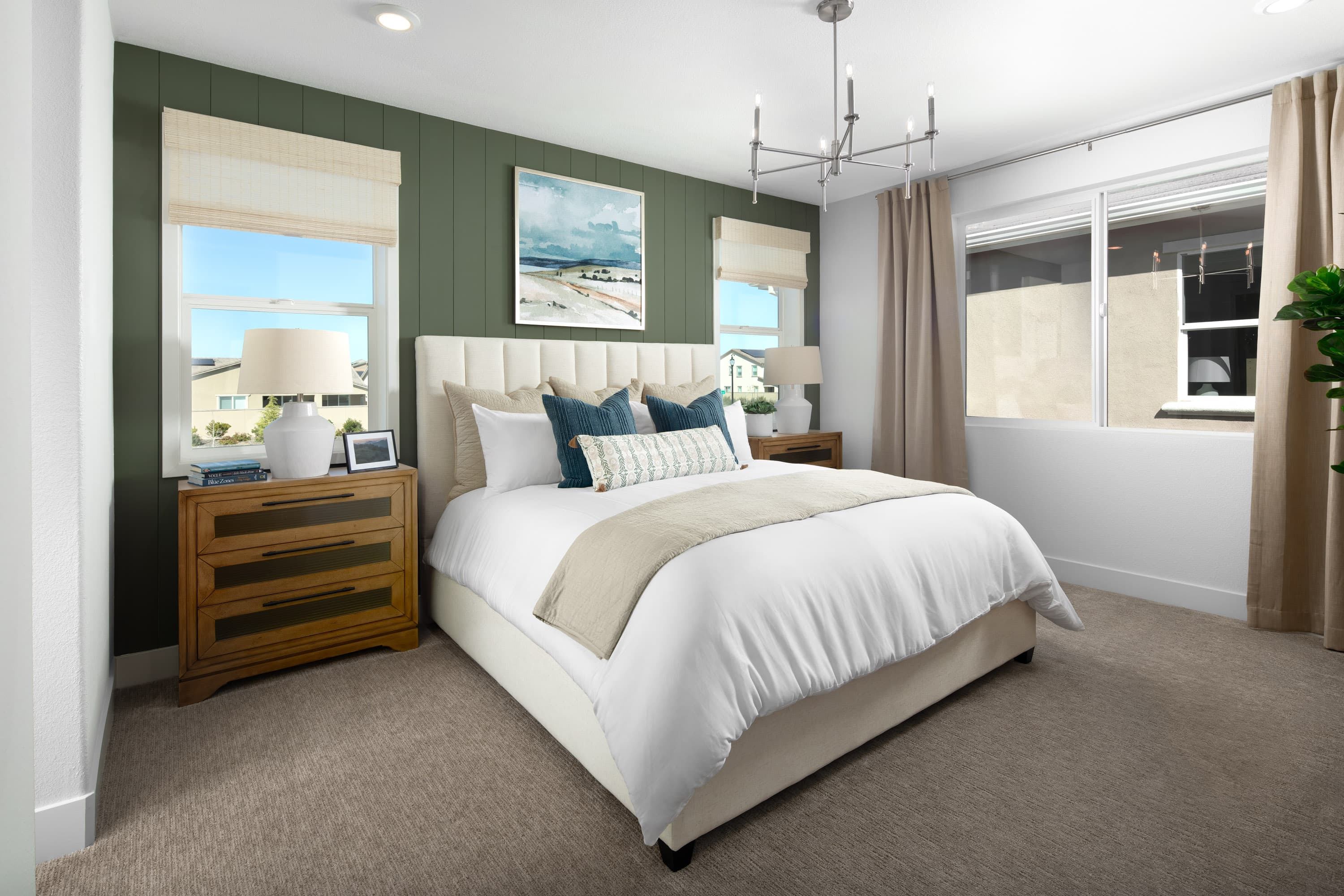 bedroom with green wall, and three windows