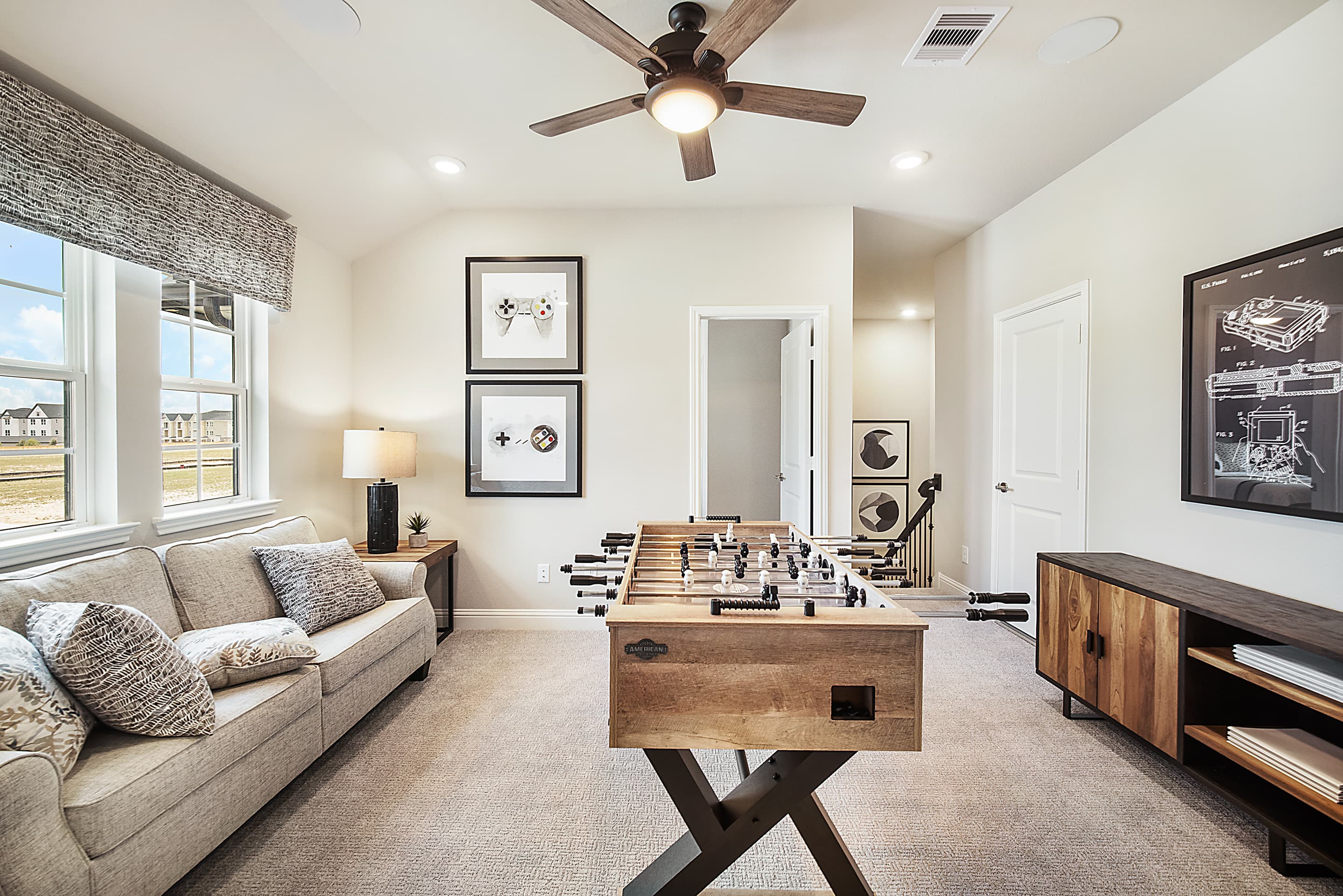 loft with foosball table and sitting area