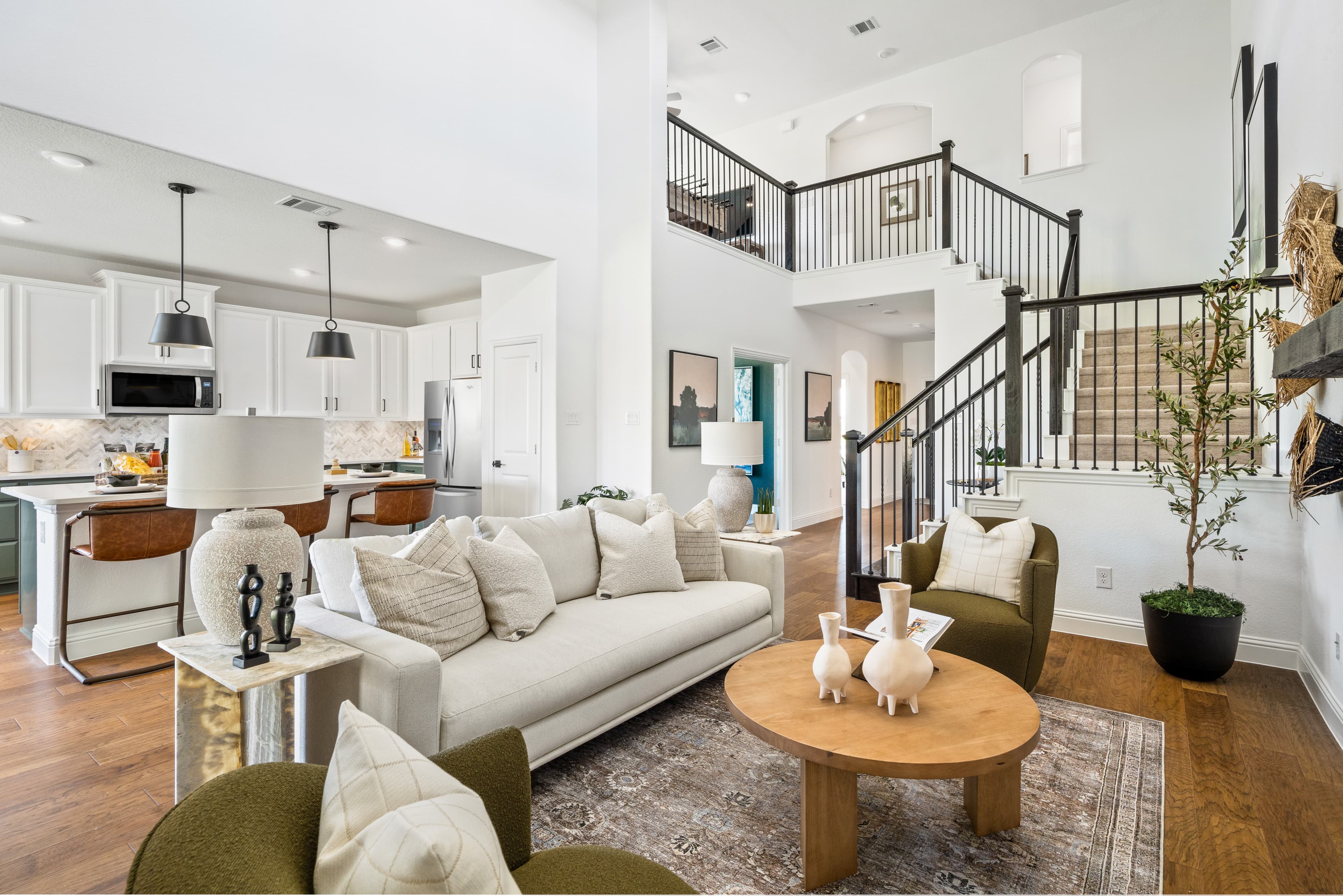 great room with wood floors and tall ceilings 