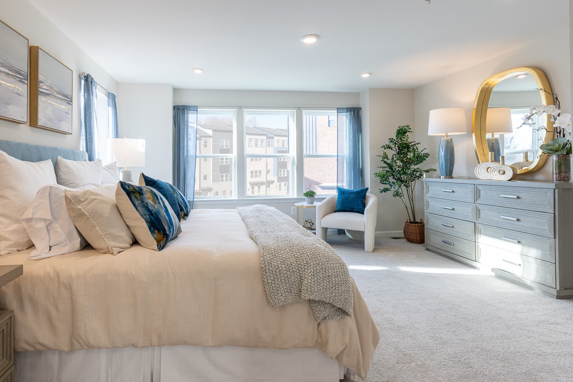 primary suite with a king sized bed and dresser