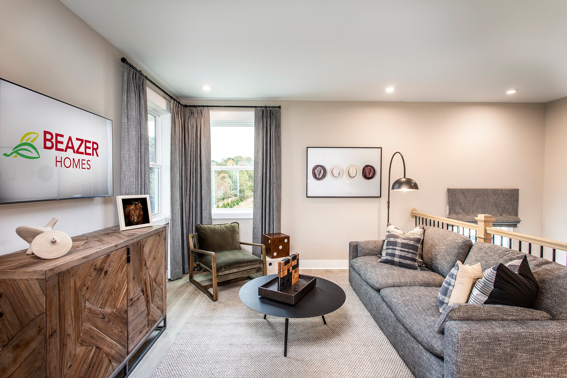 loft with plank flooring and gray couch 