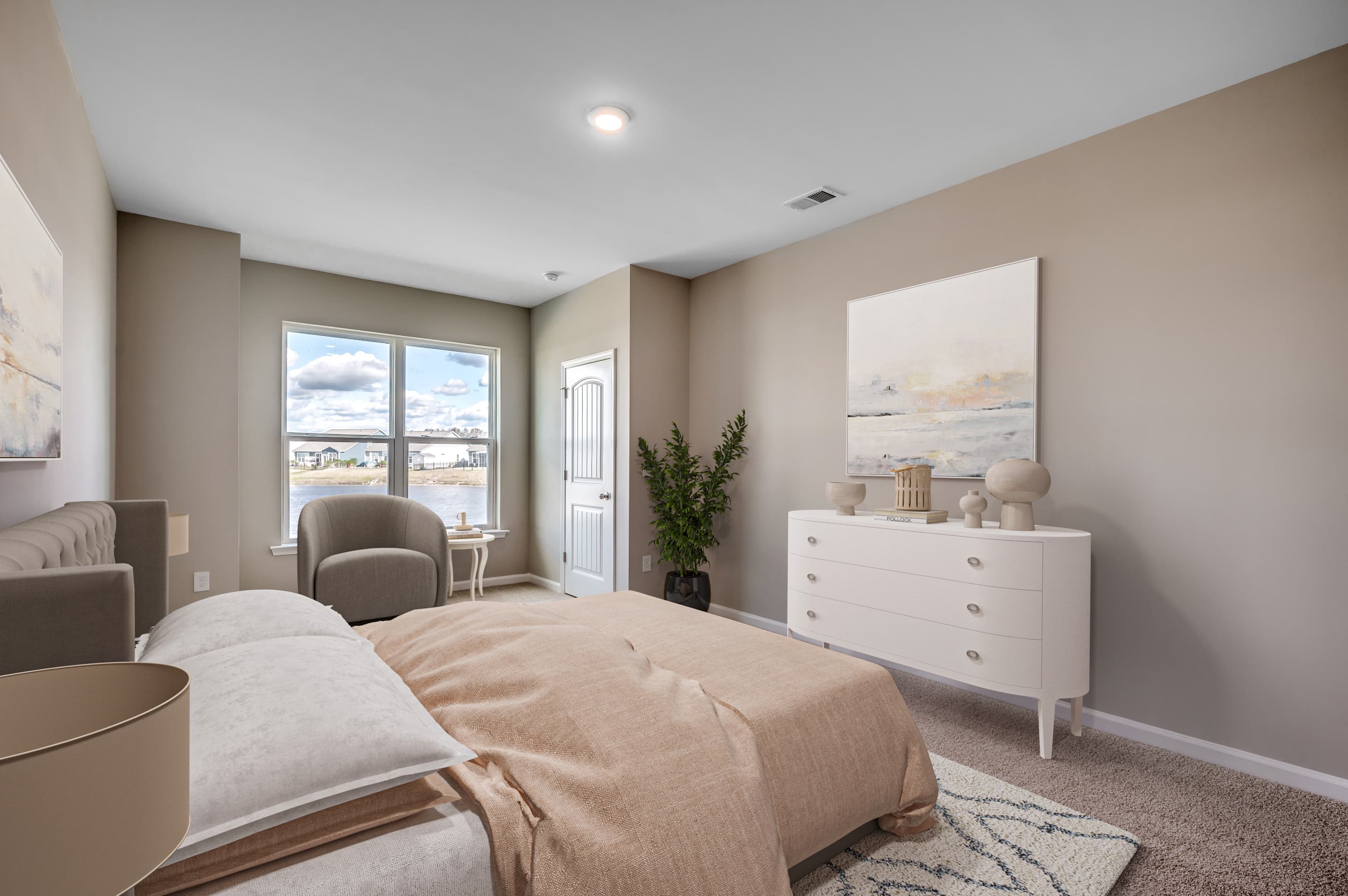 large primary bedroom with tan walls 