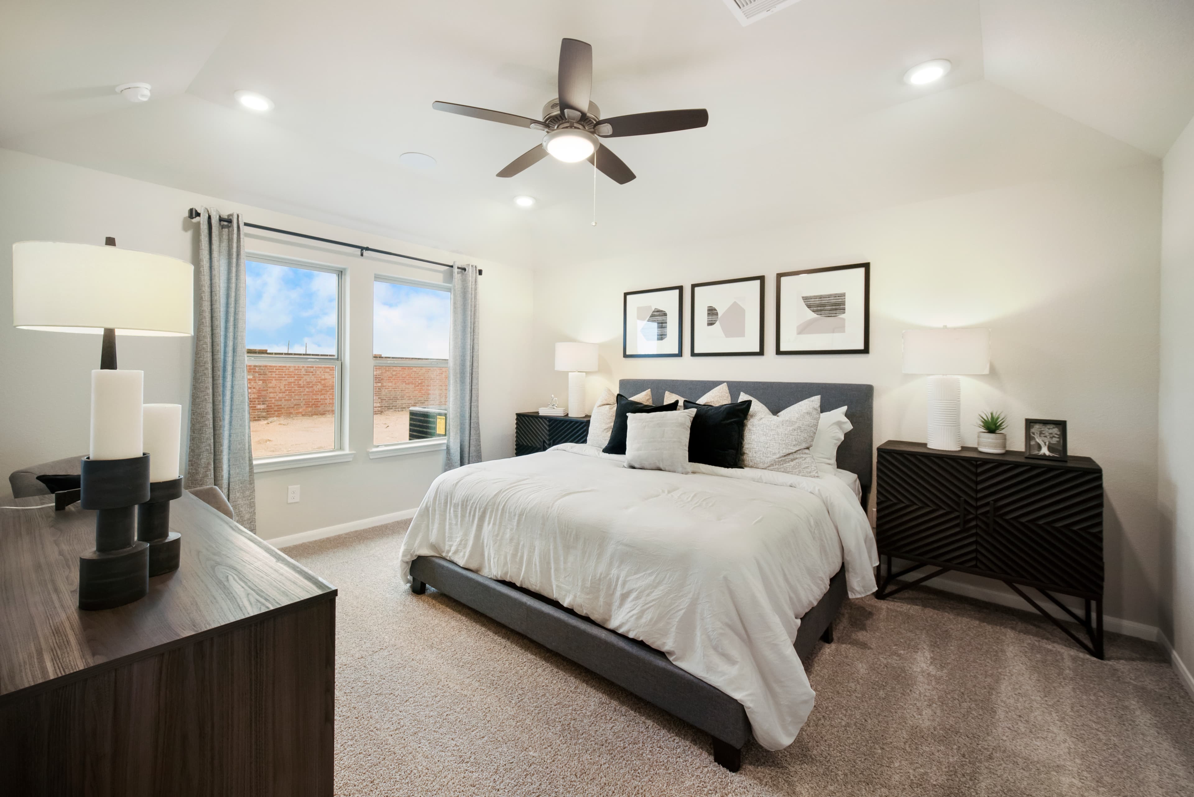 primary bedroom with wall art and nightstands