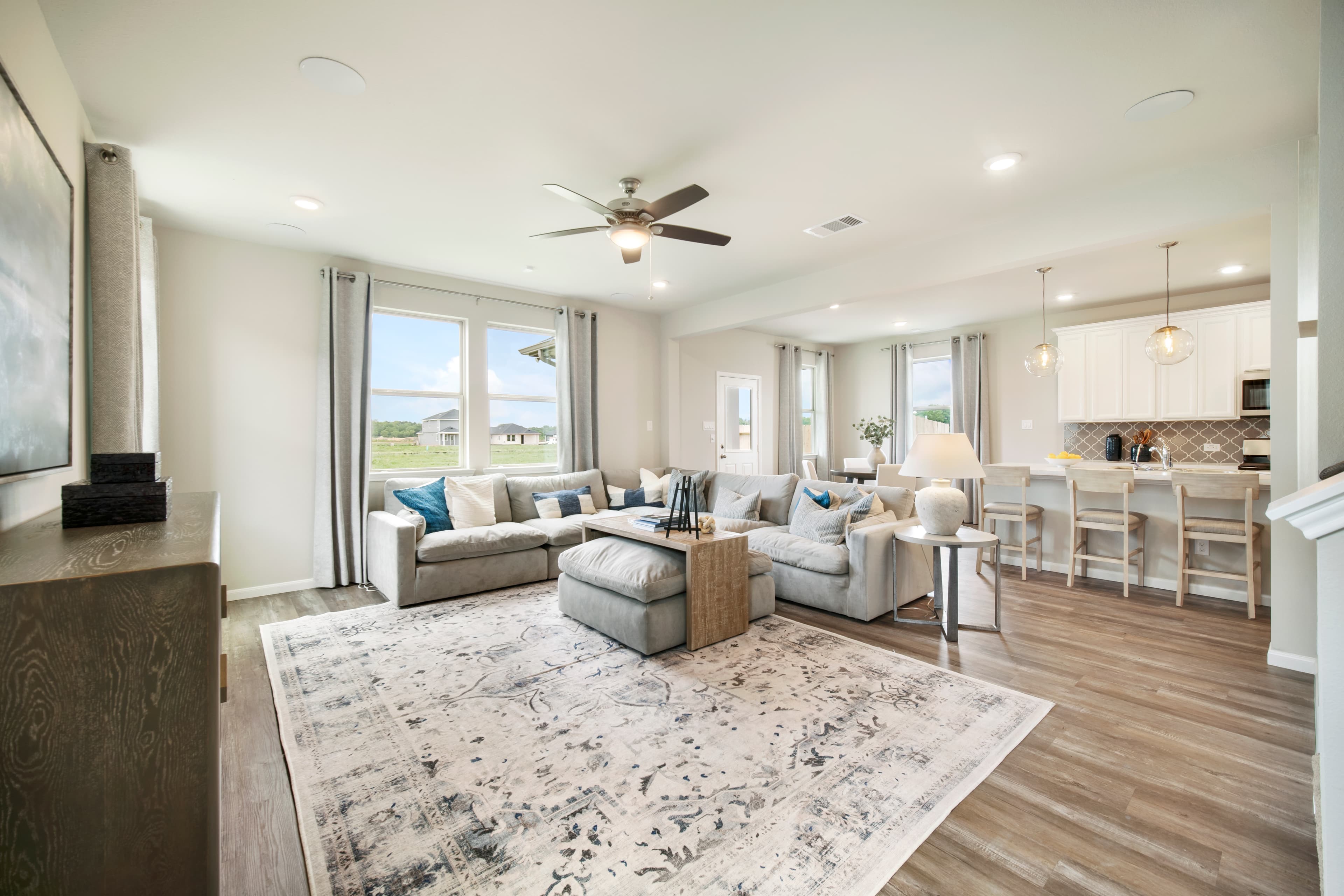 great room with ceiling fan