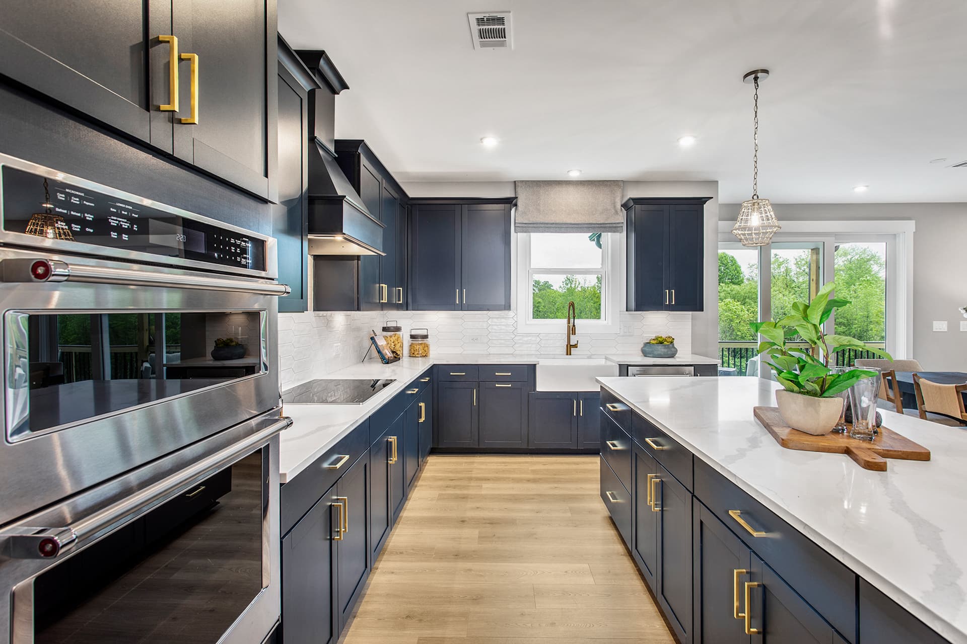 kitchen with dark cabinets & white quartz counters