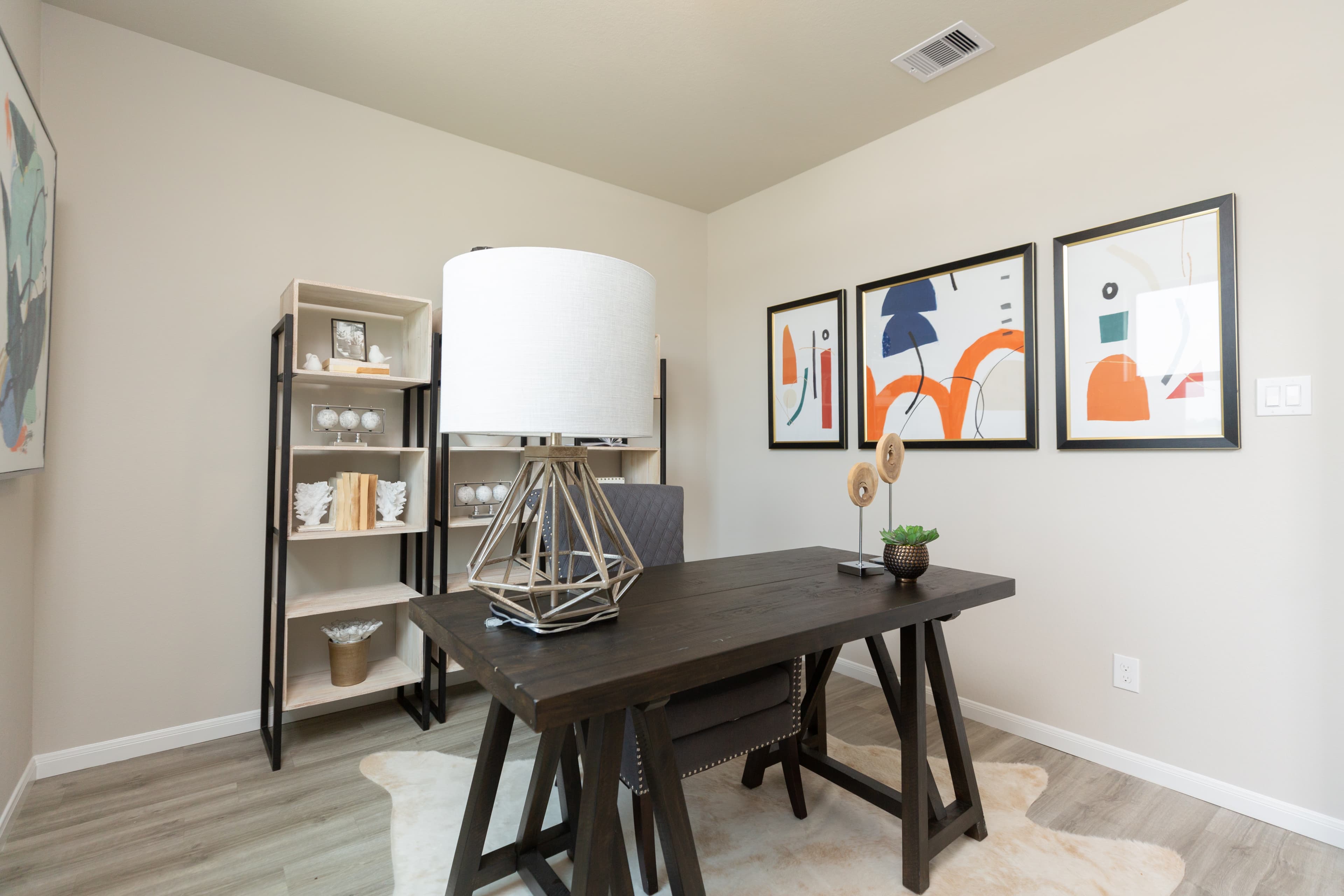 study with dark wooden desk and large table lamp