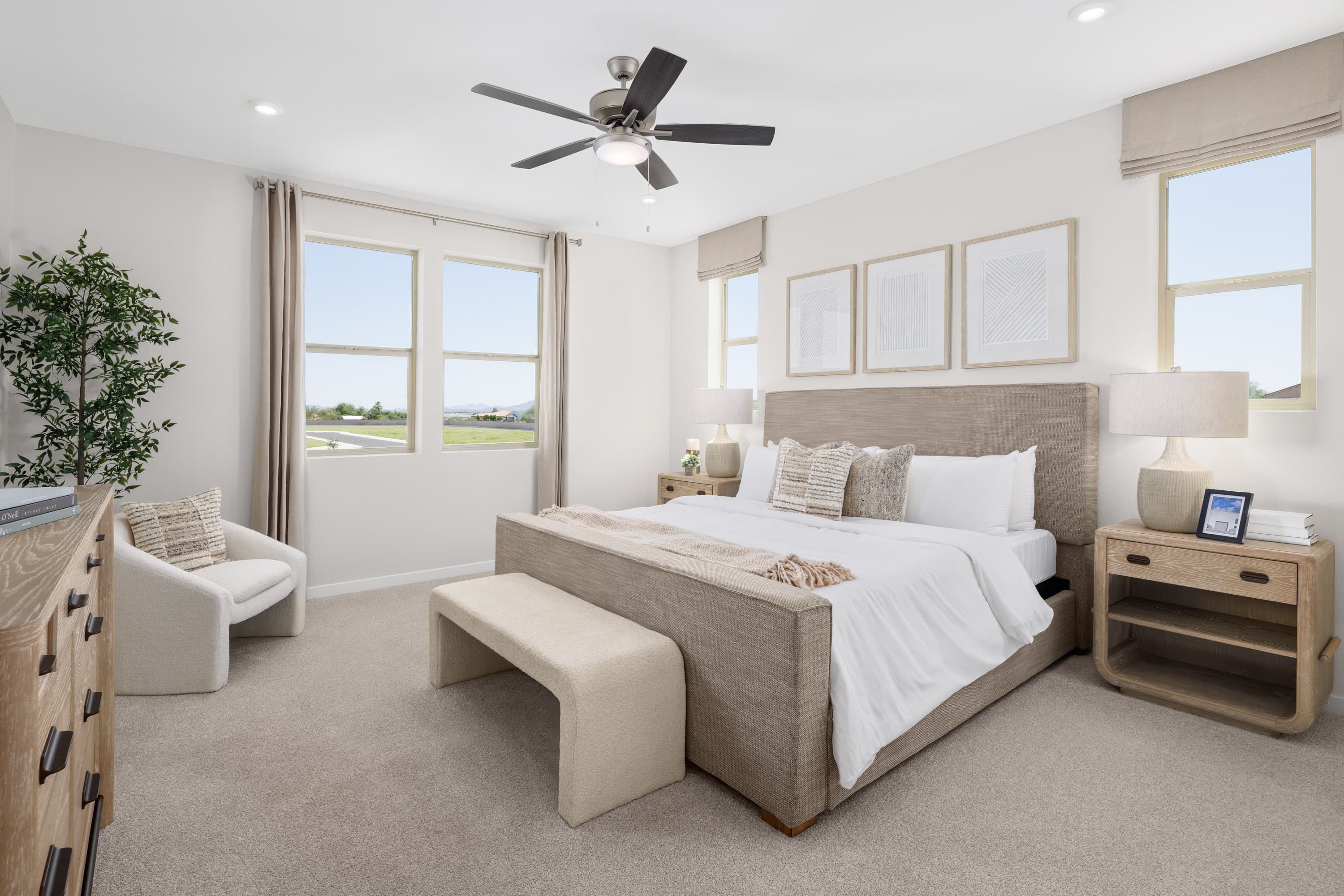 large beige bed with wooden dresser and nightstand