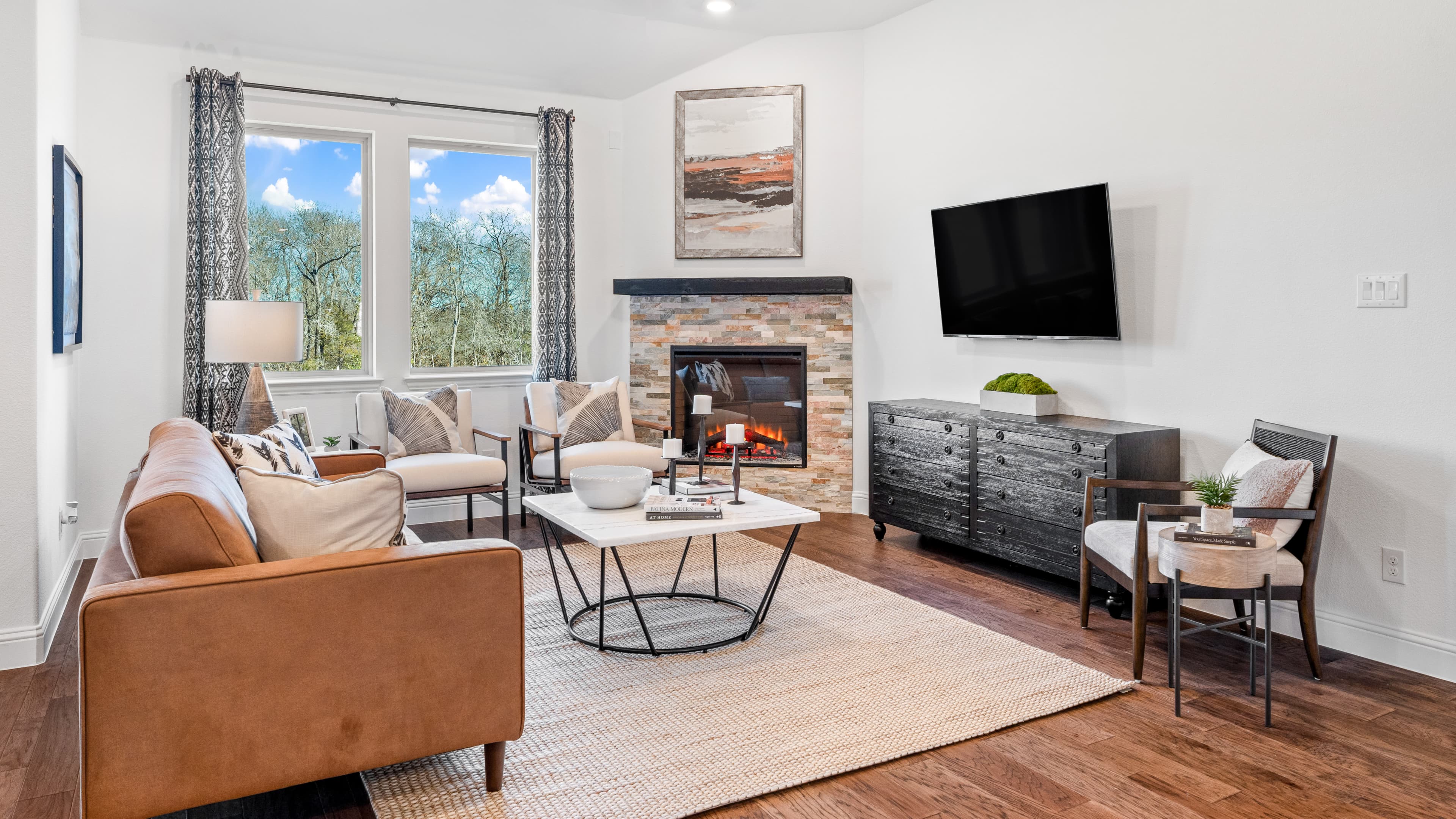 great room with wood floors and fireplace