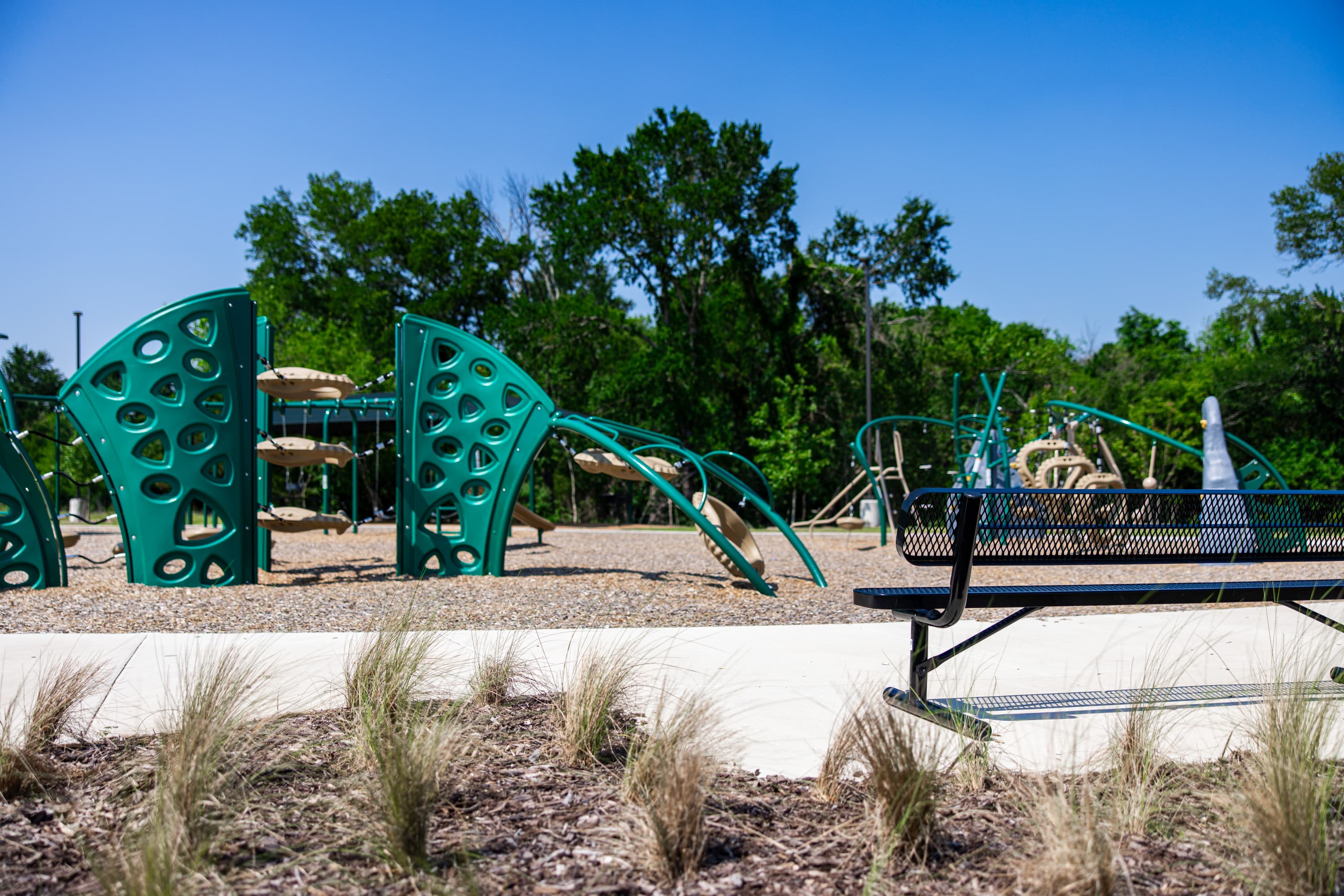 playground with jungle gym and bench