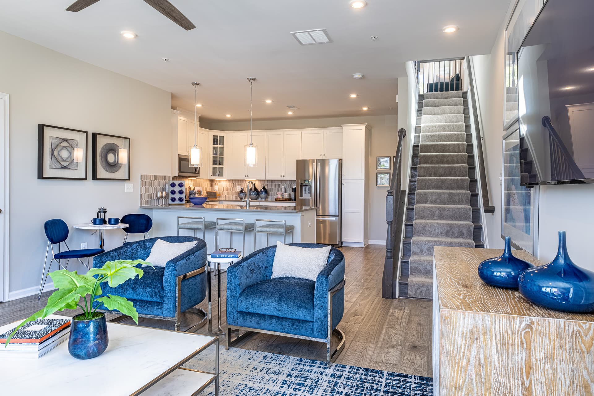 great room with 2 blue statement chairs